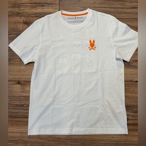 Woman’s Psycho Bunny White Tee with Orange Emblem. Size 5